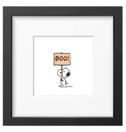 Snoopy holding up a peach coloured sign reading BOO, framed Peanuts print in a black frame