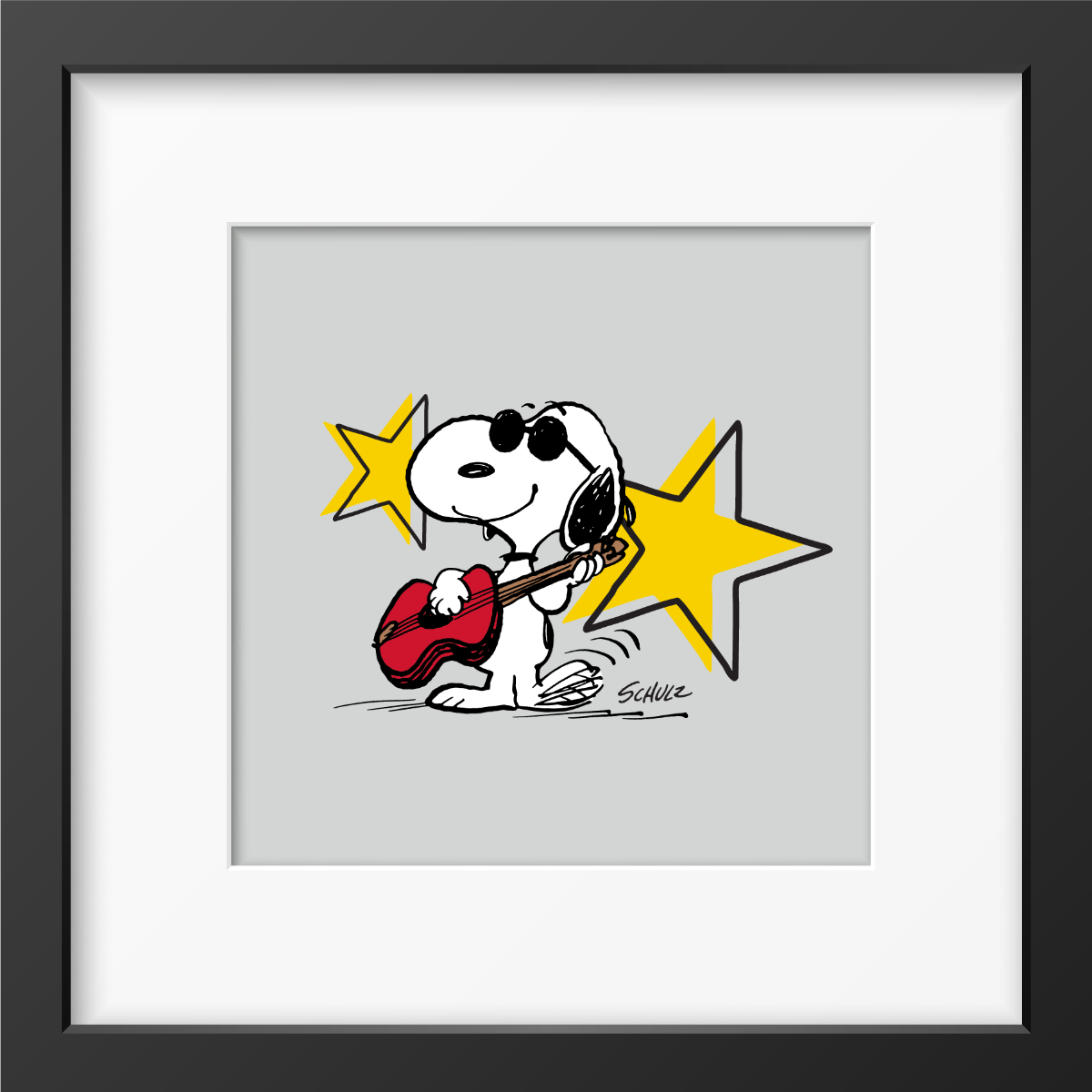 Snoopy wearing black sunglasses playing a red guitar in front of two yellow stars on a grey background, framed Peanuts print